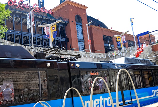MetroLink train at Stadium Station with Busch Stadium in background.