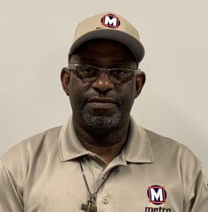 Headshot of TSM Tim standing in front of a beige colored wall
